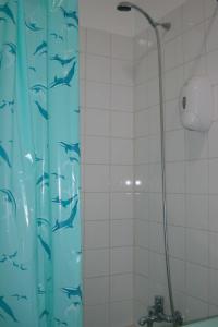 a shower curtain with fish on it in a bathroom at Studio near the beach in Albufeira