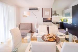 a kitchen and living room with a table and chairs at Apartment Ivana 2435 in Malinska