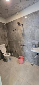 a bathroom with a shower and a toilet and a sink at Muskan home stay in Ujjain