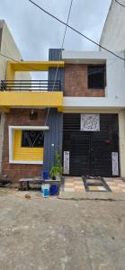 a brick house with a black garage at Muskan home stay in Ujjain