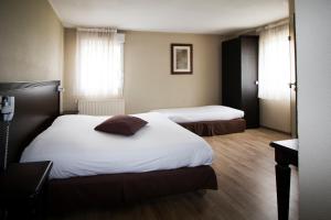 Postel nebo postele na pokoji v ubytování Ambiance Hotel