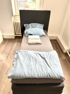 a bed with a blanket and a pillow on it at Pension Jasmin A in Chemnitz +39 photos
