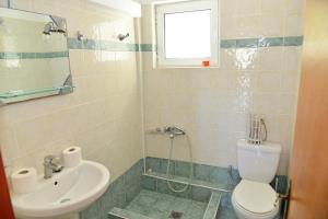 a bathroom with a toilet and a sink at Korali in Almiropótamos