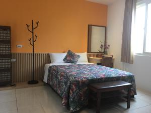 Voodi või voodid majutusasutuse Palm Tree Hotel Kenting toas