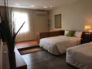 Voodi või voodid majutusasutuse Palm Tree Hotel Kenting toas