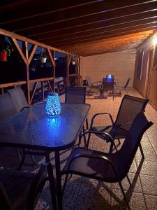 a table and chairs on a patio at night at Casa Armonia Costinesti in Schitul