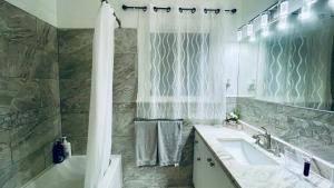 a bathroom with a tub and a sink and a shower at Amazing Home Near Toronto Airport with 2 Parking in Toronto +31 photos