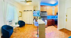 a kitchen with blue chairs and a refrigerator at south beach apartment 5 min walk to the ocean in Miami Beach +2 photos