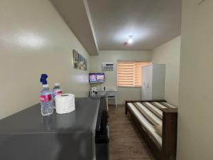 a room with a counter with two bottles of water at Stanford Suites 3, staycation near Nuvali, located in Silang in Bayabasan