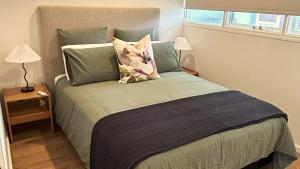 a bedroom with a large bed with two pillows at Stunning Modern Self-contained Apartment in Beaumont