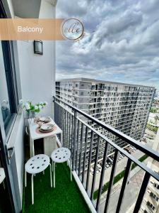 a balcony with a table and two chairs and a building at Modern Unit at Shore 2 Mall of Asia by Elle Suite in Manila +57 photos