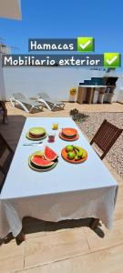 a white table with plates of fruit on it at Luna Nueva con Jacuzzi in Tarajalejo