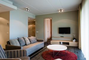 a living room with a couch and a tv at Kuressaare Marina Apartment in Kuressaare