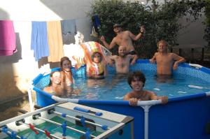 a group of people in a swimming pool at Bliss Inn Hostel & Tours in Shkodër