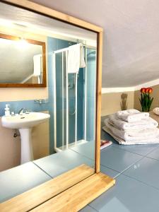a bathroom with a shower and a sink and a mirror at Nanni's House in Quartu SantʼElena +26 photos