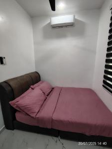 a bed in a room with a purple blanket at Supa Dupa Homestay Merbok 2 in Kampong Merbok