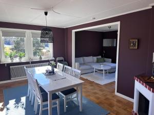 a living room with a white table and a couch at Naturnära Ängen Ödegården in Trollhättan