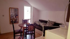 a living room with a couch and a table at Guest House Bogat-Beden in Ravda