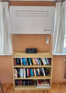 a room with a book shelf with books at Apartment to Düsseldorf - near Airport DUS - Trade Fair - Arena in Düsseldorf