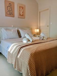 a bedroom with a large bed with a orange blanket at Aktaea, Seaside Residence in Santa Maria