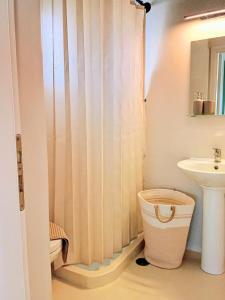 a bathroom with a shower with a toilet and a sink at Aktaea, Seaside Residence in Santa Maria +29 photos