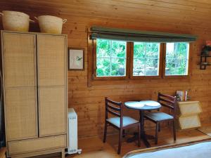a room with a table and two chairs and a window at An Cábáin Cúlú in Killarney