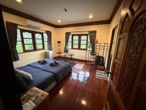 a bedroom with a bed in a room with windows at Sweet home in Bangrak Beach