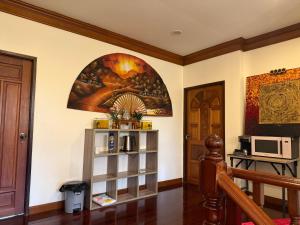 a living room with a painting on the wall at Sweet home in Bangrak Beach