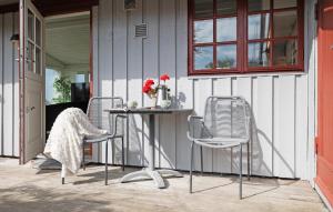 a patio with chairs and a table on a house at Lovely Home In Gørlev With Wifi in Gørlev