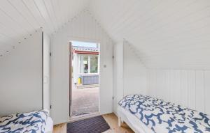 a white room with a bed and a window at Lovely Home In Gørlev With Wifi in Gørlev +2 photos