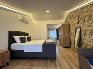 a bedroom with a large bed and a wooden floor at Villa Maldives, right on sea in center of Fethiye in Fethiye