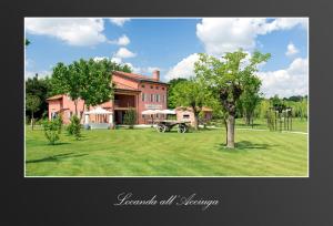 a large red brick house with a tree in the yard at Locanda Acciuga MM in Piazzola sul Brenta