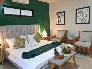 a bedroom with a bed and a table and chairs at Tambisan Resort in Siquijor