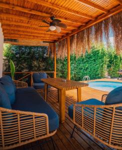 a patio with a table and chairs and a pool at Boheme Bungalow Sapanca in Sapanca
