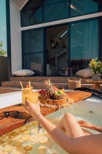 a woman laying in a swimming pool holding a drink at Boheme Bungalow Sapanca in Sapanca