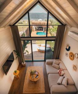 a room with a couch and a large window at Boheme Bungalow Sapanca in Sapanca