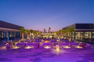 une terrasse avec des chaises et des tables violets en face d'un bâtiment dans l'établissement Rixos Obhur Jeddah Resort & Villas - All-Inclusive, à Djeddah 80 autres photos