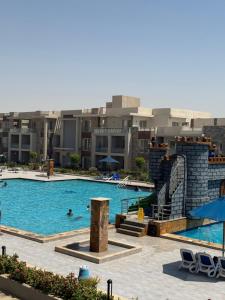 a pool at a hotel with people swimming in it at Elite residence ain elsokna in Ain Sokhna