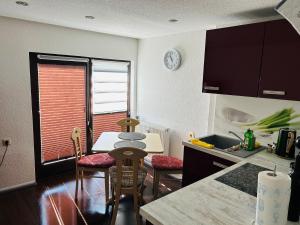 a kitchen with a table and chairs and a sink at Fewo Leo in Remse
