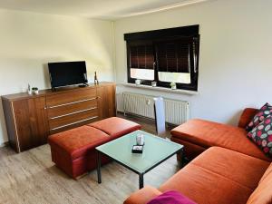 a living room with a couch and a table at Fewo Leo in Remse