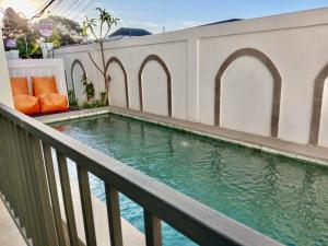 a swimming pool on the balcony of a building at South Island Bali -Near Uluwatu in Jimbaran