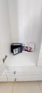 a shelf with a clock and a box on it at TORRE LAPILLO Fronte Mare in Centro con parcheggio coperto in Torre Lapillo