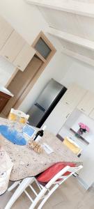 a table and chairs in a room with a ceiling at TORRE LAPILLO Fronte Mare in Centro con parcheggio coperto in Torre Lapillo +32 photos