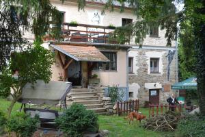 a house with a dog standing in front of it at Statek Vojtěšín in Vojtěšín