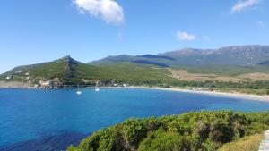 a view of a beach with boats in the water at Campelle Soprana in Pietracorbara