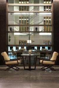 a dining room with a table and chairs and a building at Esperos Palace Luxury & Spa Hotel in Kastoria