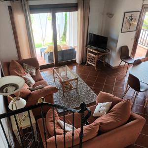 a living room with two couches and a television at Villa Déborah in Cuile Pazzoni +9 photos