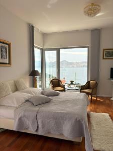 a bedroom with a large bed and a large window at Shimmer & Shine in Baška +140 photos