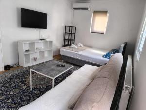 a living room with a couch and a tv at Apartments Malin in Mostar