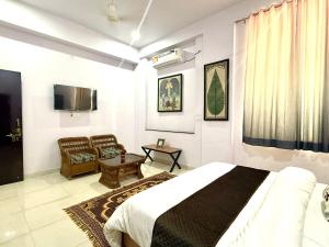 a bedroom with a bed and a living room at KURJA by Modern Haven in Jāmb
